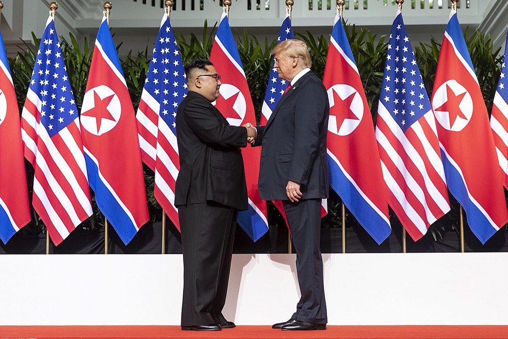 1024px-Kim_and_Trump_shaking_hands_at_the_red_carpet_during_the_DPRK–USA_Singapore_Summit.jpg